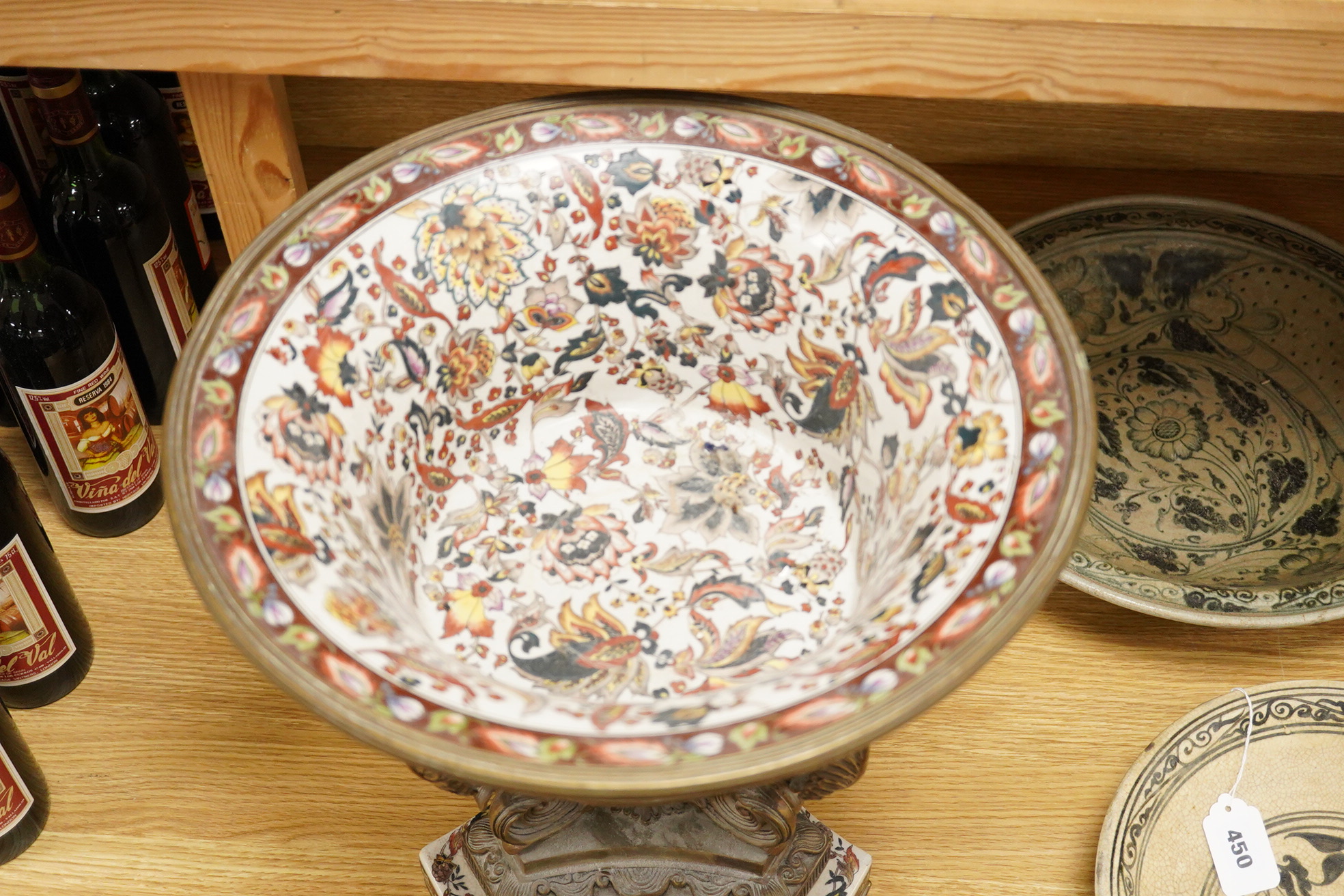 An early 20th century enamelled porcelain and ormolu mounted centrepiece with tripod scroll base, 41cm high